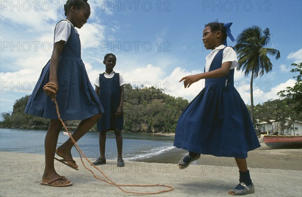 WEST INDIES, St Lucia, Anse La Raye, Schoolgirls with skipping rope