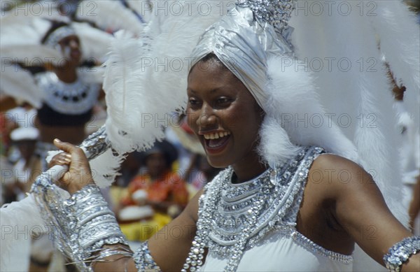 WEST INDIES, Barbados, Crop Over, Woman in silver and white costume at traditional harvest festival to celebrate bringing in the sugar cane crop