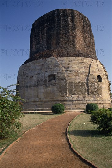 INDIA, Uttar Pradesh, Sarnath, "Dhamekh Stupa, elaborately carved brickwork with path leading up to it"