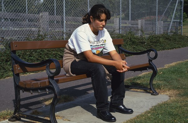 HEALTH, Moods, Teenager, Teenage girl on park bench looking sad and thoughtful.