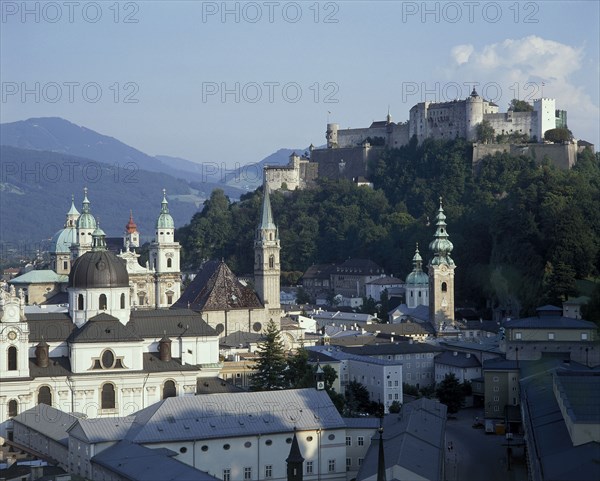 AUSTRIA, Salzburg Province, Salzburg, Hohensalzburg Fortress on wooded hill beyond the city rooftops