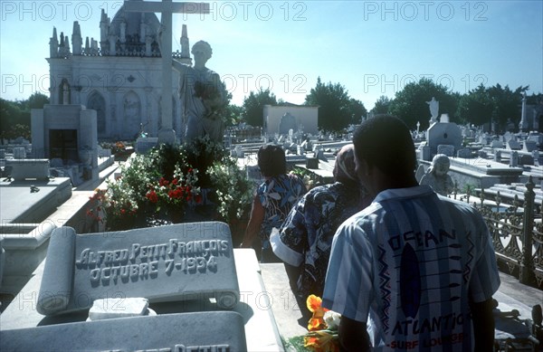CUBA, Havana, People walking through graveyard on Fathers Day
