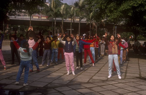 CHINA, Guangdong, Guangzhou, School children exercising outdoors