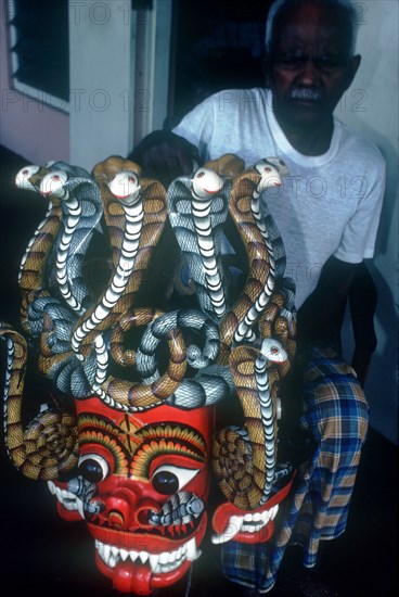 SRI LANKA, Ambalangoda, Old master wood carver displaying mask