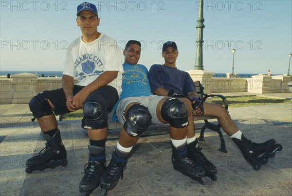 WEST INDIES, Puerto Rico, San Juan, Three teenage boy rollerbladers.