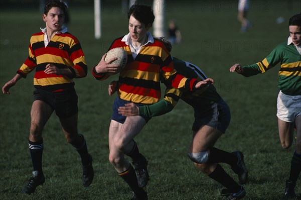 10045937 SPORT Ball Games Rugby Junior boys team  player being tackled by the opposition.