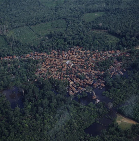 INDONESIA, Sumatra, Aerial view of small town built around a mosque showing radial formation of town