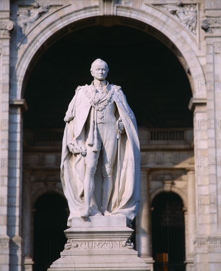 INDIA, West Bengal , Calcutta, Statue of Lord Curzon on pedestal framed by stone archway.
