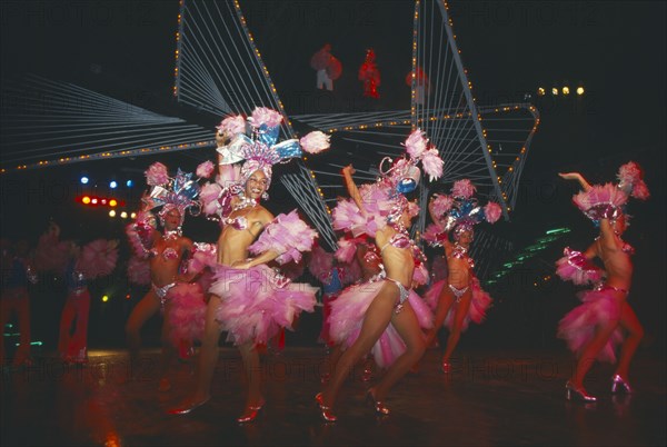 CUBA, Havana Province, Havana, Female Club Tropicana dancers on stage with singers on overhead walkway
