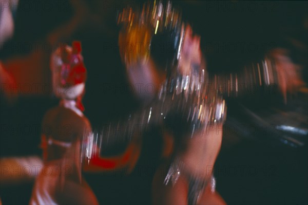CUBA, Havana Province, Havana, Club Tropicana dancers in blurred movement through long camera exposure