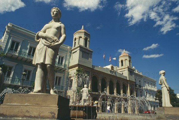 WEST INDIES, Puerto Rico, San Juan, Plaza Des Armas with statues around fountain in front of The Intendencia the former Spanish colonial exchequer
