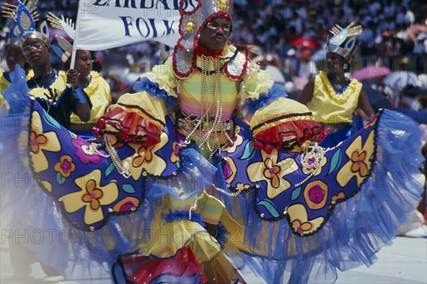 WEST INDIES, Barbados, Crop Over, Man in multicoloured costume at traditional harvest festival to celebrate bringing in the sugar cane crop