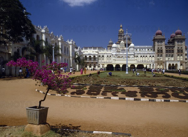 INDIA,  , Mysore, Maharaja’s Palace.  Exterior facade with visitors and people working in grounds.