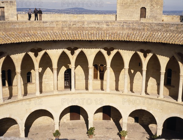 SPAIN, Balearic Islands, Majorca, Palma.  Bellver Castle.  Cloistered circular courtyard of keep and people viewing