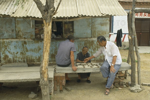 CHINA, Kaifeng , Men playing Chinese Chess