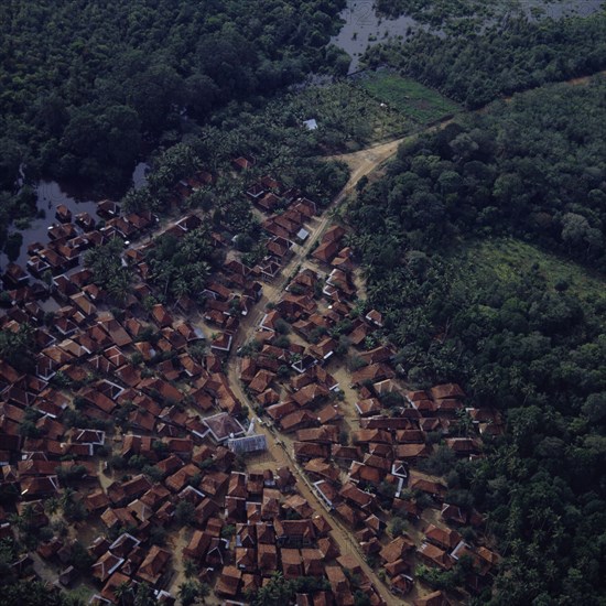 INDONESIA, South, Sumatra, "Aerial view of village,central mosque,wetlands & secondary jungle. Radial development of town"
