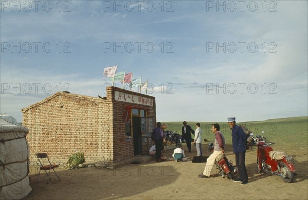 MONGOLIA, Agriculture, Sheep, Mongolians gathering for sheep work with motorbikes and bicycles parked