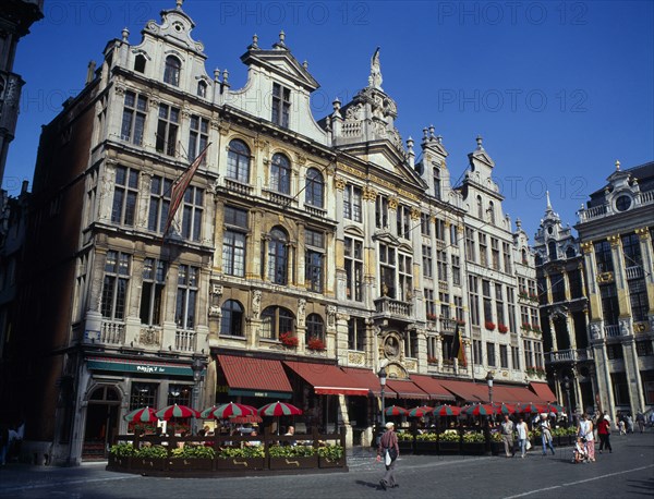 BELGIUM, Brussels, Grand Place, Highly decorated buildings in the historic square with outdoor restaurants and umbrellas.