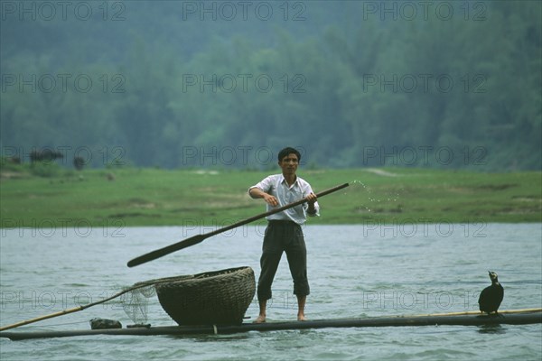 CHINA, Fishing, Fisherman in boat with Cormorants