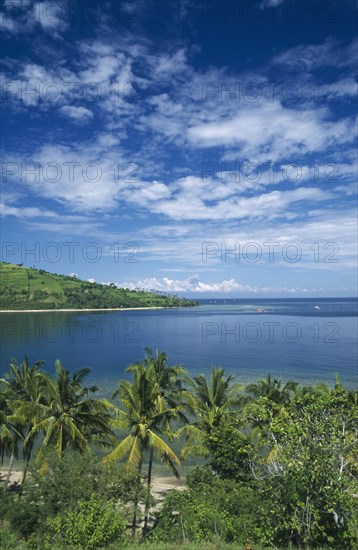 INDONESIA, Lombok , Sengiggi Area, Coastline north of Senggigi with Mount Agung on Bali visible in the distance