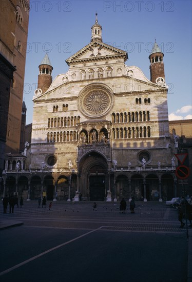 ITALY, Emilia Romagna , Cremona, "Il Duomo exterior facade with people, children and pigeons in square in the foreground. "