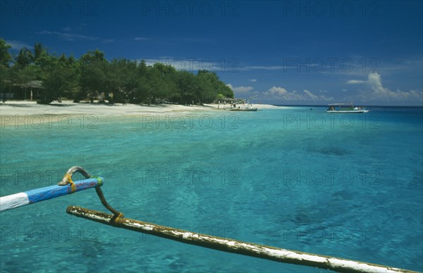 INDONESIA, Lombok, Gili Islands, Gili Trawangan beach seen from approaching outrigger canoe in clear water