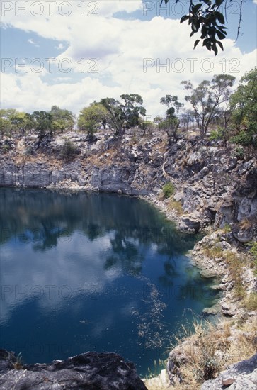 NAMIBIA, Damara, Lake Otjikoto, Sink Hole formed from collapsed cavern with rocky surround