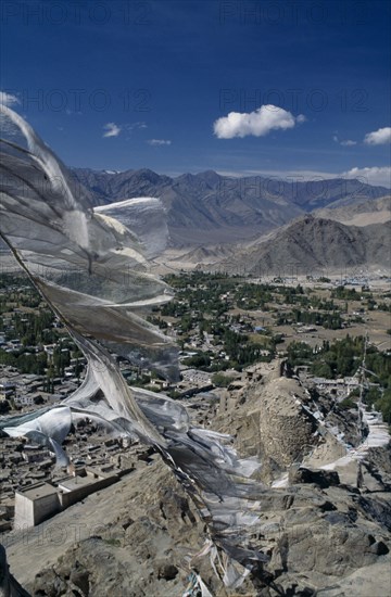 INDIA, Ladakh Region, Leh Valley, Prayer Flags flying over Leh surrounded by mountain range.
