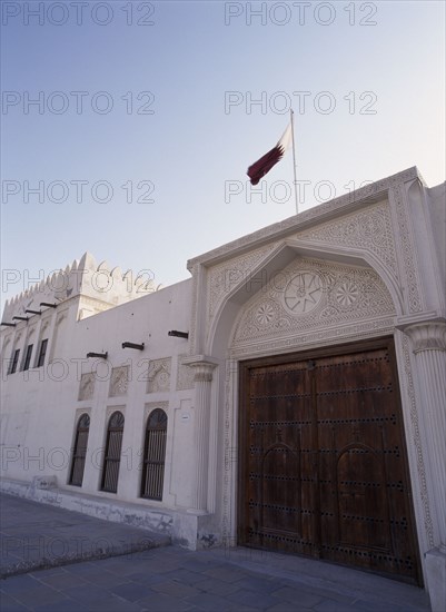 QATAR, Doha, Doha Fort.  Exterior view showing ornate doors with the Qatar flag flying above.