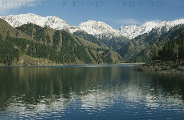 CHINA, Xinjiang , Lake Tianchi, View over the lake toward snow capped mountain peaks