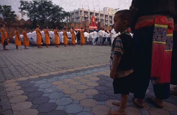 THAILAND, North, Chiang Mai, Child watching ordination of novice monks.