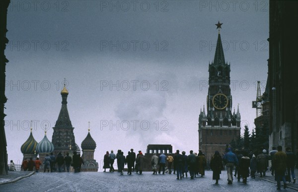 RUSSIA,  , Moscow, Red Square in winter with crowds and spires of St Basils Cathedral and clock tower