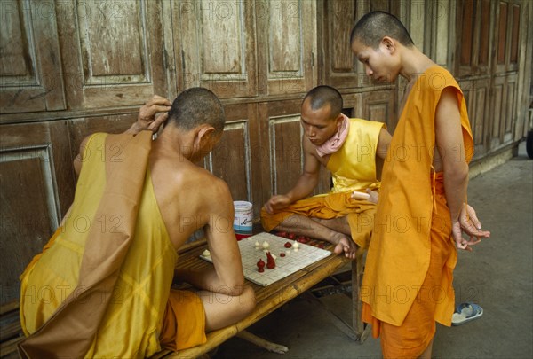 THAILAND, Bangkok , Buddhist Monks playing chess in Bangkok monastery.