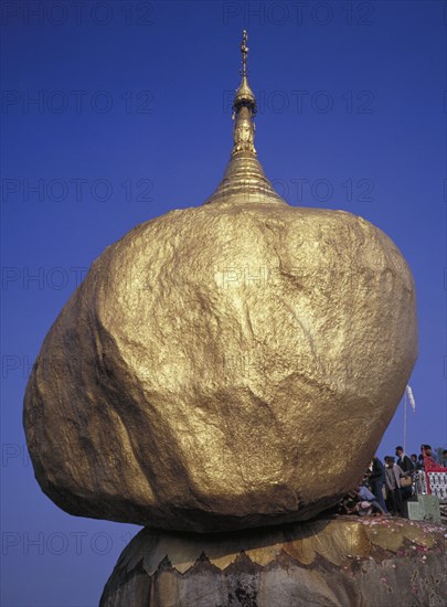 MYANMAR, Pegu, Kyaiktiyo, Pilgrims at the Golden Rock Pagoda a precariously perched head shaped rock Burma