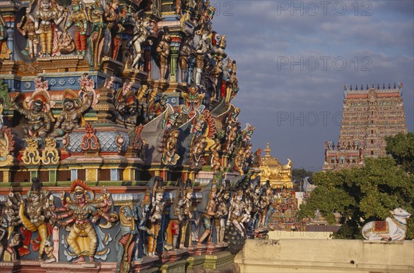 INDIA, Tamil Nadu , Madurai , Sri Meenakshi Temple exterior.  Detail of colourful carved gopuram.