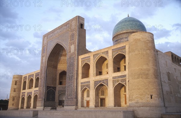 UZBEKISTAN, Bhukhara, Mir I Arab Madrassah Mosque facade and dome seen in evening light