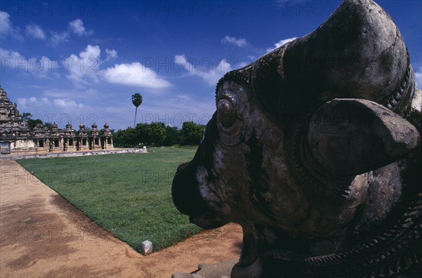 INDIA, Tamil Nadu, Kanchipuram, Kailasanatha Temple dedicated to Siva and dating from the 7th Century.  Part view of exterior with statue of Nandi bull facing temple in immediate foreground.