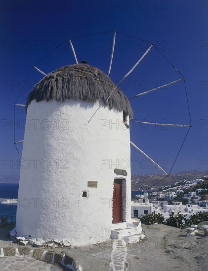 GREECE, Cyclades Islands, Mykonos, Thatched and whitewashed harbour windmill now a folk museum above the town