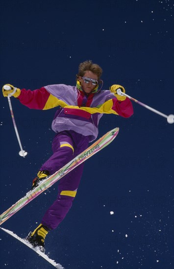 USA, Colorado , Vail, Lone acrobatic skier in mid air pose against deep blue sky