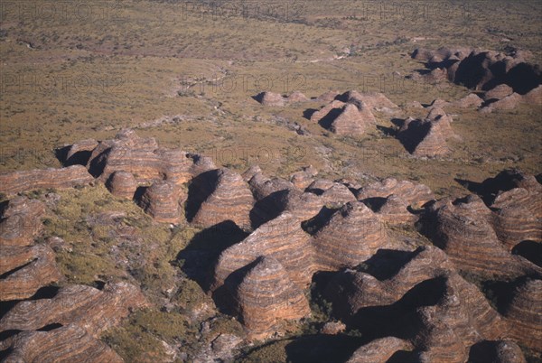 AUSTRALIA, Western Australia, Bungle Bungle National Park, Aerial view over the striped rock towers made up of layers of orange silica and black lichen
