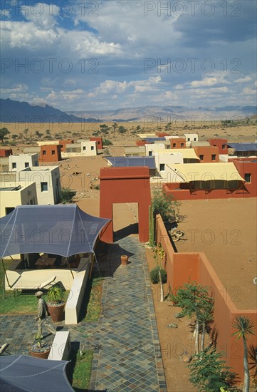 NAMIBIA, Namib Desert, Sussusvlei, Karos Lodge. View over cluster of Hotel buildings on the edge of the desert