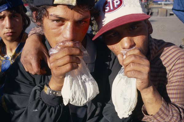 BULGARIA, Sofia, Solvent Abuse. Two gypsy boys sniffing glue from plastic bags
