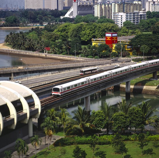 SINGAPORE, MRT Nr Kallang, MRT Mass Rapid Transport Train Nr Kallang Station On Kallang River. Road Traffic On Sir Arthur's Bridge. Apartment Blocks. J6828