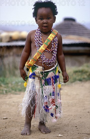 SOUTH AFRICA, KwaZulu Natal, Melmoth, Young Zulu Girl dressed up by her sisters in traditional clothes