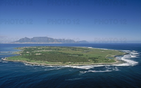 SOUTH AFRICA, Western Cape, Robben Island, Aerial view of the prison island with table Mountain in the distance