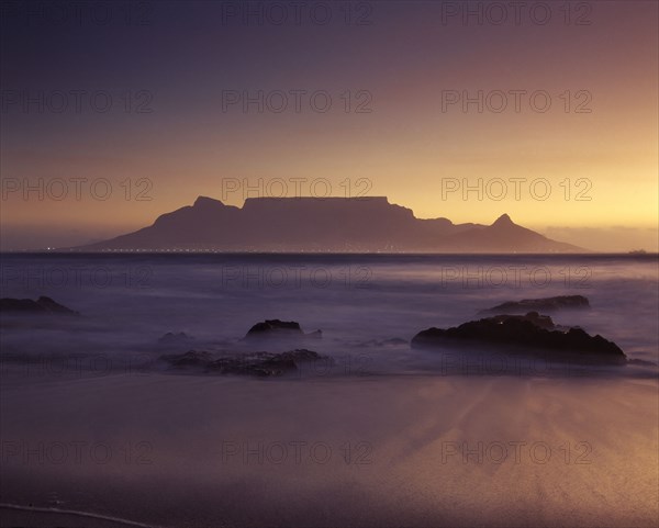 SOUTH AFRICA, Cape Province, Cape Town, View of Table Mountain at dawn taken from Bloubergstrand shore line