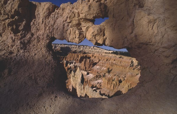 USA, Utah, Bryce Canyon National Park , View through natural arch toward valley of colourful rock pinnacles