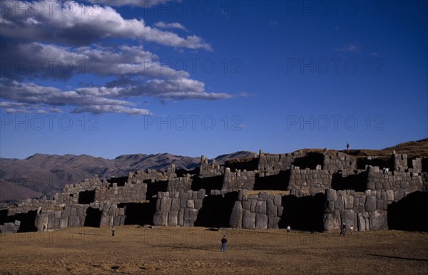 PERU, Cusco, Sacsayhuaman, 15th Century Inca fortress ruins built from enormous bolders with nearby tourists