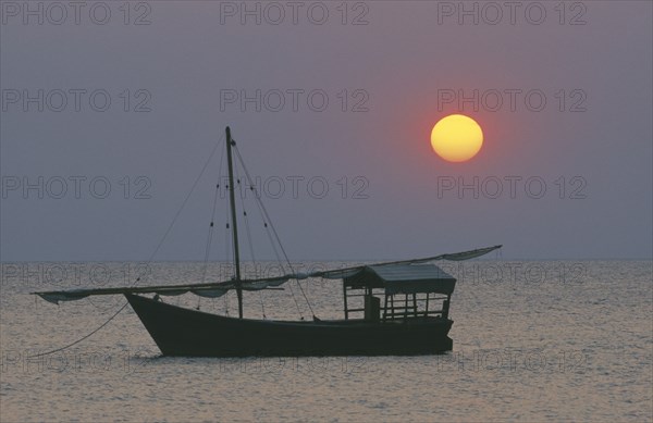 TANZANIA, Lake Tanganyika, Sunset with dhow at anchor