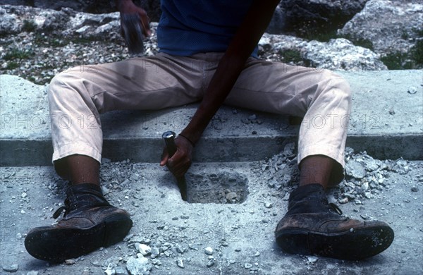 CUBA, Work, Detail of construction worker chiseling into concrete